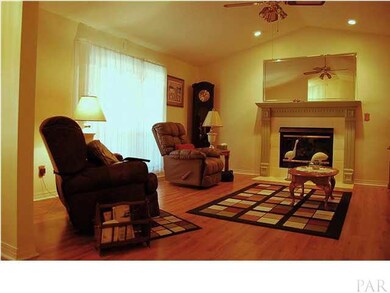 View of living room where the fireplace with gas log is focal point.