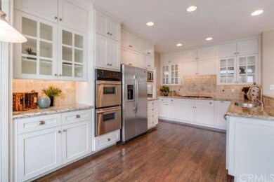 Gorgeous white-washed cabinets, warm wood floors a