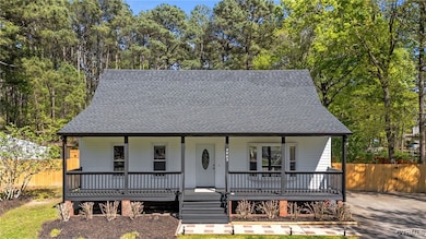 View of front of property featuring fence, a porch