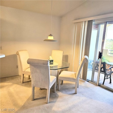 Dining space featuring light carpet and baseboards