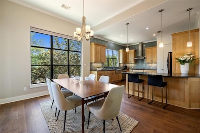 Dining space with crown molding, a chandelier, da