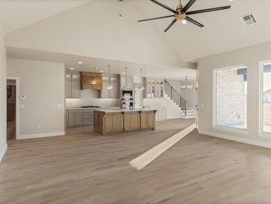 Kitchen featuring ceiling fan with notable chandel