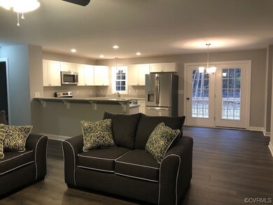 Living roomwith hardwood Floors, ceiling fan
