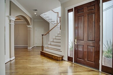 Foyer leading to beautiful staircase and arched entry to dining room.
Recently refinished hardwoods on first floor.
