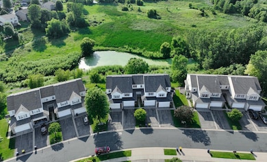 Aerial view of pond and exterior of home
