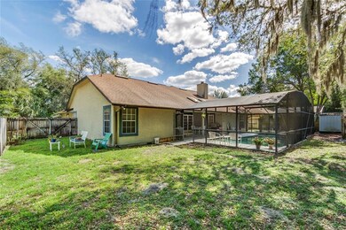 Fenced backyard with screen enclosed pool