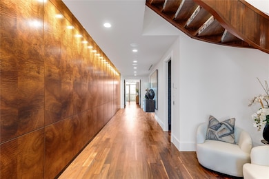 Hall with hardwood / wood-style floors