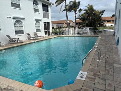 Heated community pool with pavered deck has access