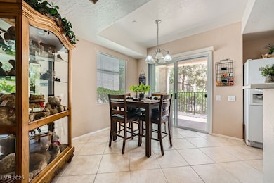 Dining room with a chandelier, light tile patterne