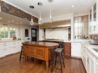 A gourmet cook's dream kitchen: La Cornue gas/electric oven, custom nickel hood, SieMatic custom cabinets lined in Norwegian walnut, warming drawer