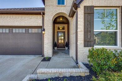 View of exterior entry with concrete driveway, bri