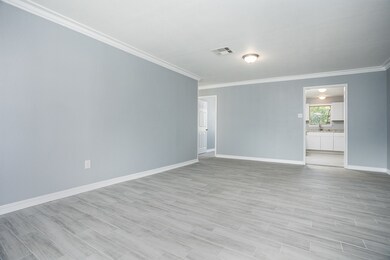 Spacious Living Room with Crown Molding and Tile P