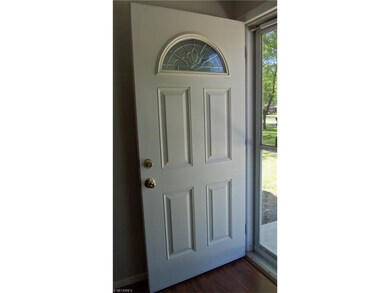 Front door opens to wood-like vinyl flooring that 