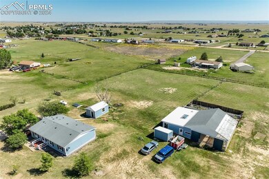 Birds eye view of property featuring a rural view