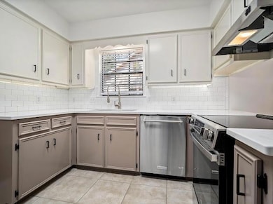 Kitchen featuring sink, light tile patterned floor