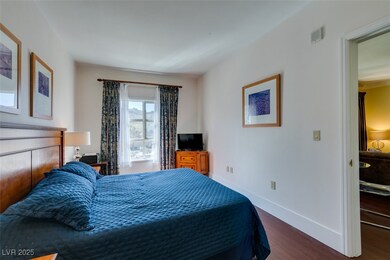 Bedroom with baseboards and dark wood-type floorin