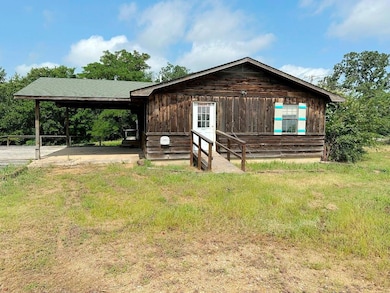 Rustic home with an attached carport and entry steps