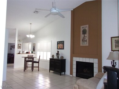 Living area with high vaulted ceiling, visible ven