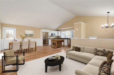 Staged area of living/dining/kitchen area. Island