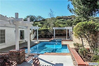 Large backyard with spa, pool, sitting area and fi