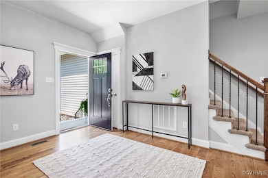 Entrance foyer with wood finished floors, stairs,