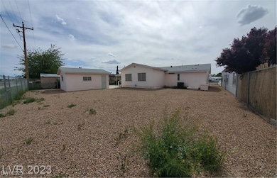 Rear view of property featuring an outbuilding, a