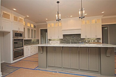 Massive kitchen with custom cabinets, five burner