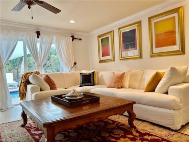 Living area with crown molding, ceiling fan, and recessed lighting