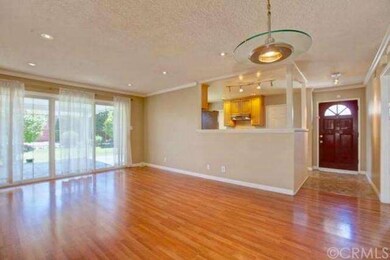 view of front door and kitchen area from living ro