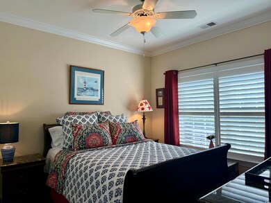 Bedroom with crown molding and ceiling fan