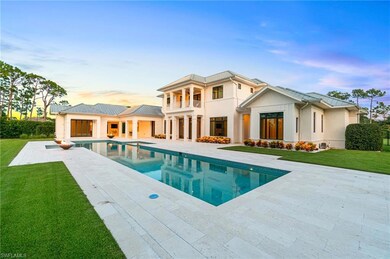 Back house at dusk featuring a patio, a balcony, a