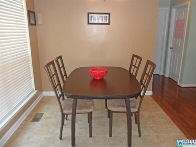 Dining area with a large window overlooking the ba