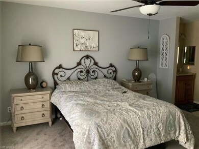 Bedroom featuring light carpet, ensuite bathroom, 