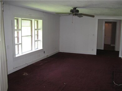 The living room is large and has a picture window.