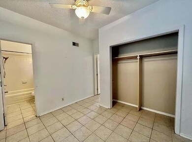 Unfurnished bedroom featuring light tile patterne