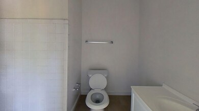 Bathroom with toilet, baseboards, and vanity