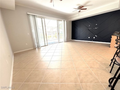 Tiled empty room with crown molding, ceiling fan,