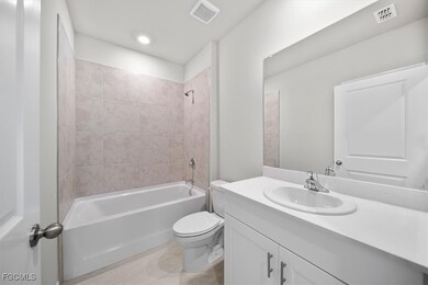 Full bath with vanity, shower / bath combination, and recessed lighting