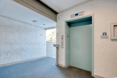 Property entrance with elevator and stucco siding