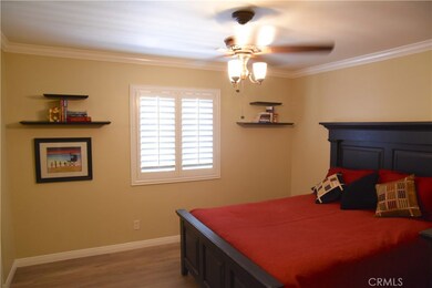Crown moulding, plantation shutters and oversized floor mouldings, as well as designer quality ceiling fan gives this large bedroom a lot of class.