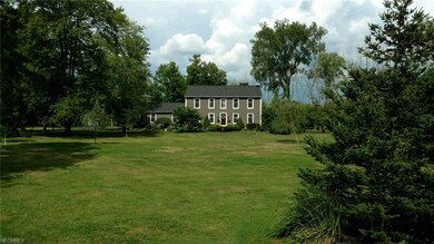 A mature, mixed-wooded setting surrounds this grac