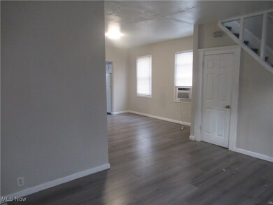Unfurnished room featuring dark hardwood / wood-style floors and cooling unit