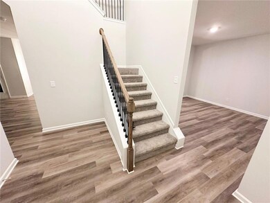 Stairway featuring baseboards and wood finished floors