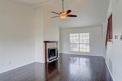 Unfurnished living room featuring dark hardwood / 