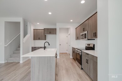 Kitchen featuring appliances with stainless steel finishes, modern cabinets, a kitchen island with sink, light wood-style floors, and recessed lighting