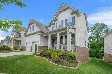 Craftsman-style house with brick siding, covered porch, driveway, a front lawn, and a garage