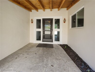 Property entrance with a patio area