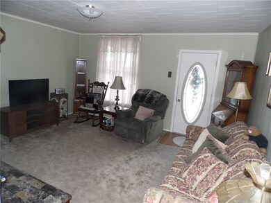 A formal living room entrance is spacious and brig