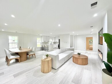 Living room with light wood-type flooring and sink
