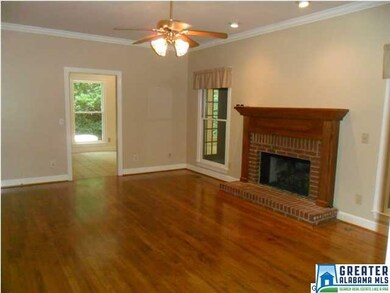 Spacious living room with fireplace and hardwood f